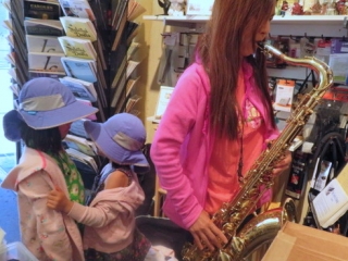 Otoe Mori tries out a tenor sax at Steve Deutsch Woodwinds